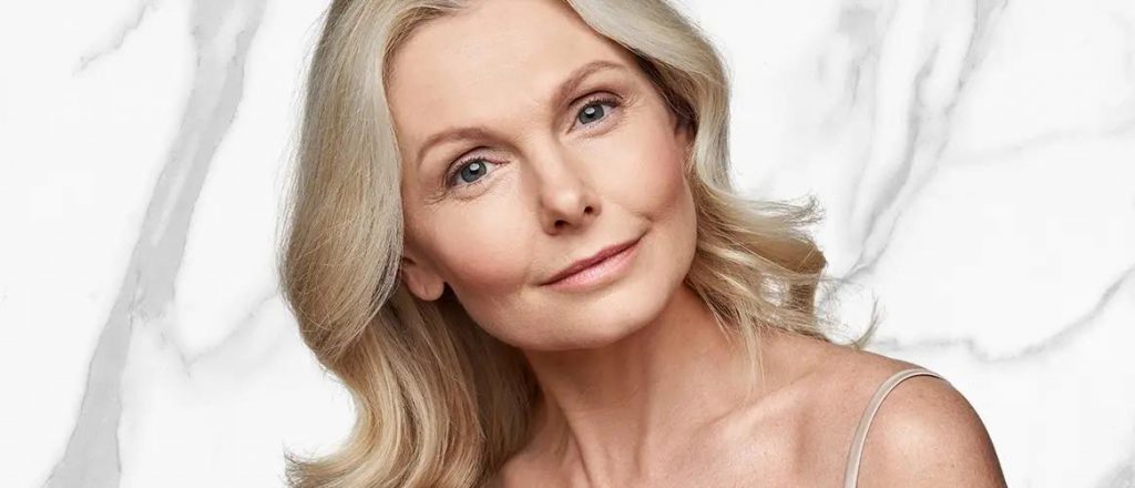 A beautiful woman is smiling after laser resurfacing treatment.